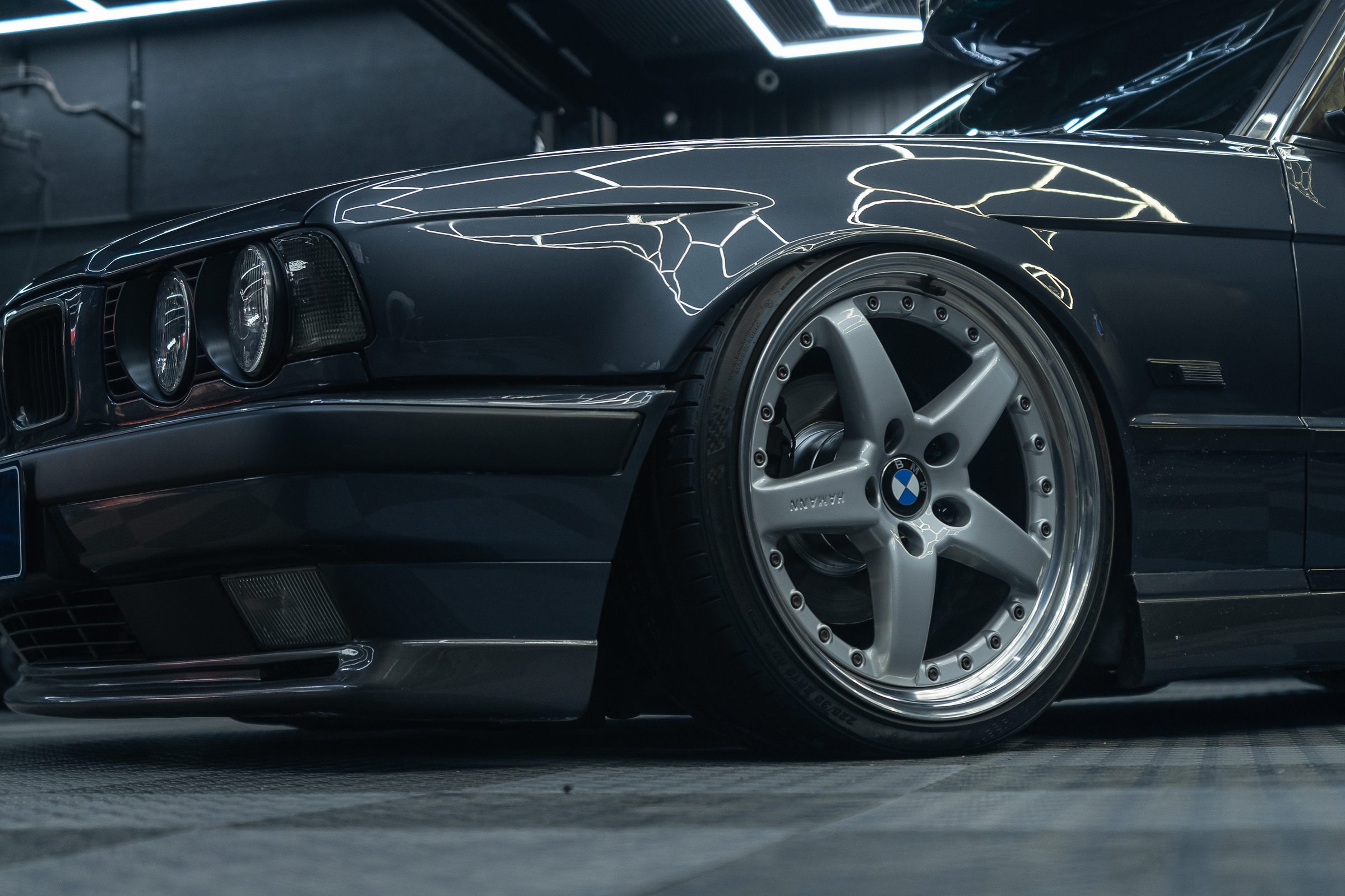 A lowered classic BMW sitting over polished wheels
