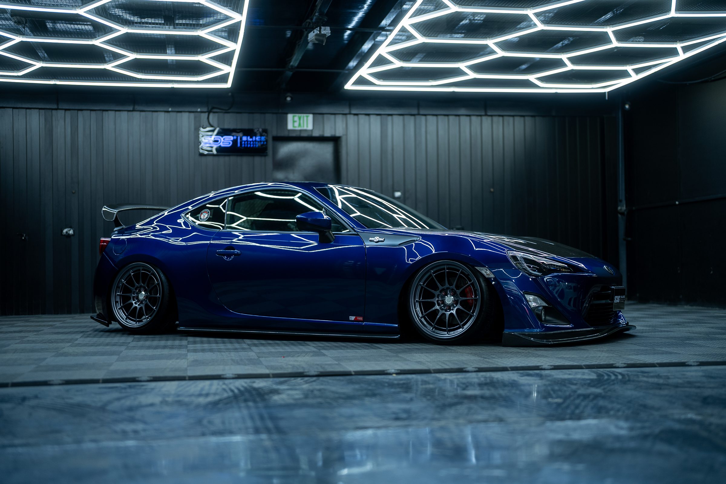 A blue Subaru BRZ under the studio lighting