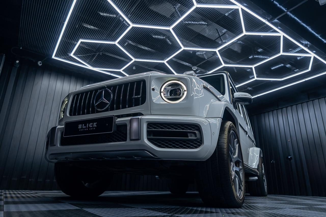 A Mercedes-AMG G-Class lit from the front