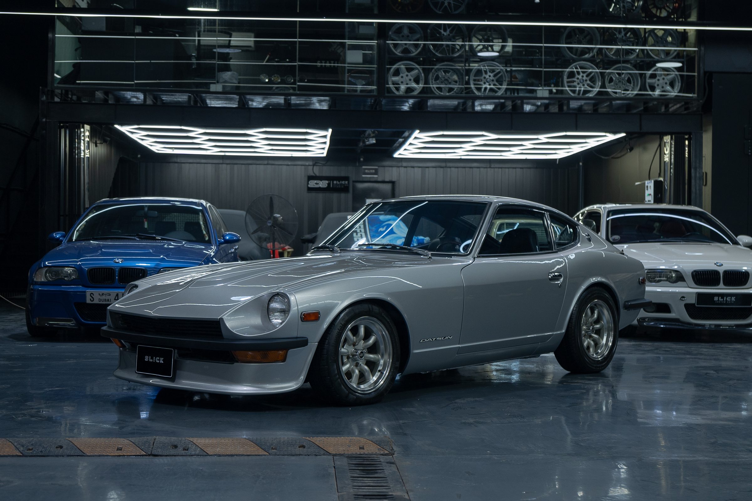 A silver Datsun 240Z under the studio lighting