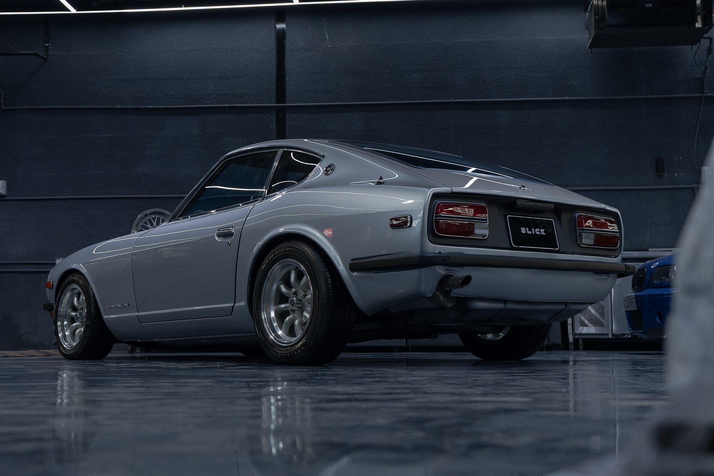 A silver Datsun 240Z photographed from the rear three-quarter
