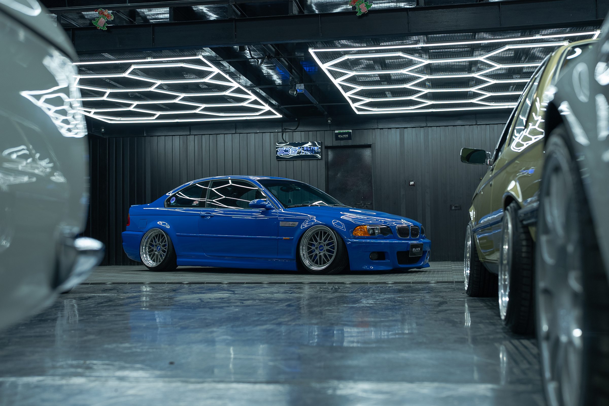 A blue BMW M3 E46 under studio lighting
