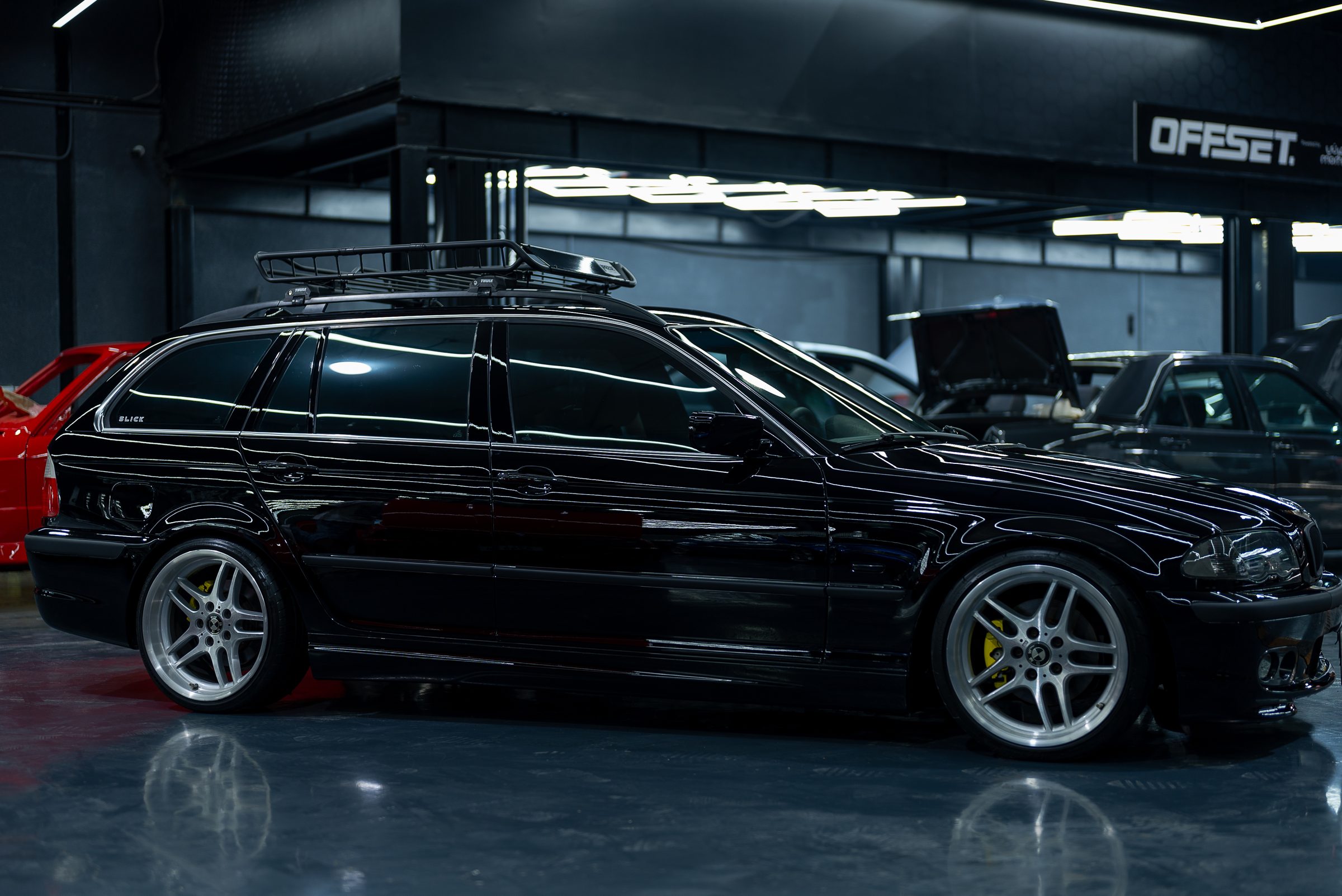 A black BMW 5 Series Touring inside the dark studio